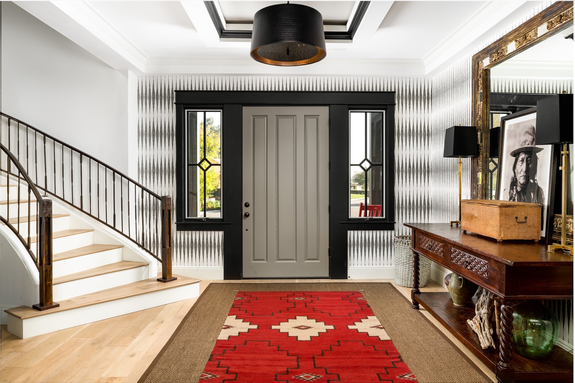 Entry hall with staircase, red runner, and wood console